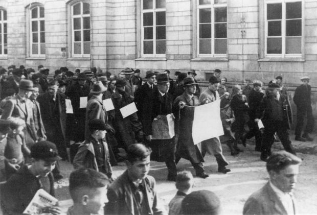 Schwarzweißfoto von Juden, die nach der Reichspogromnacht 1938 von zahlreichen Menschen durch die Straßen von Bautzen getrieben werden.
