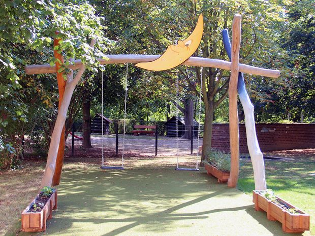 Aus Holz gebaute Schaukel mit Mond an der höchsten Stelle