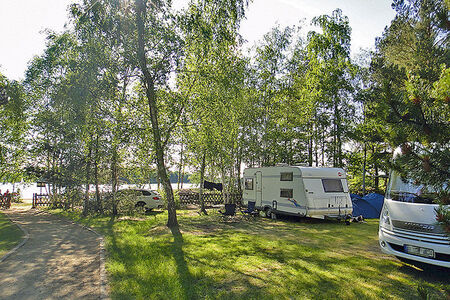 Wohnwagenstellplätze und Zeltwiese, See im Hintergrund