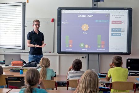 Smart Board Kinder sitzen im Unterricht. Ein Lehrer stellt die neue elektronische Tafel vor