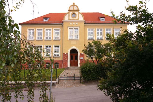Fichte Grundschule - orangenes Gebäude, untere Mauer mit roten Ziegeln