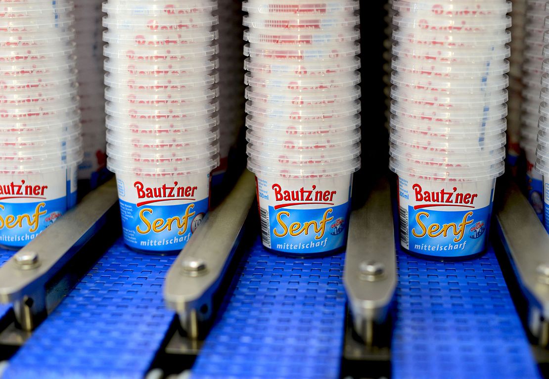 leere gestapelte Bautz’ner Senf Becher in Produktionsmaschine